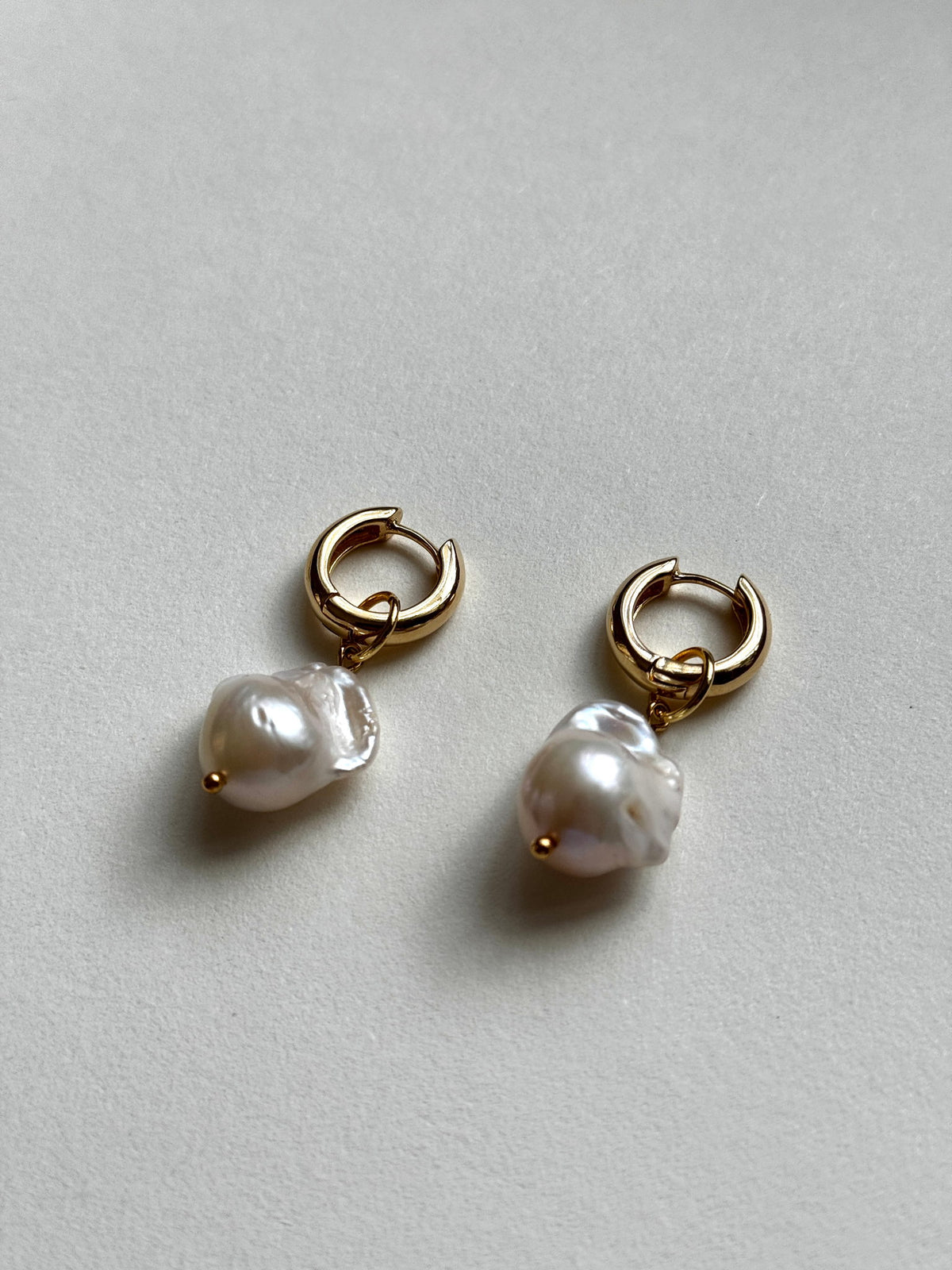 Baroque Pearl Hoops, angled view of the huggie hoops and baroque pearl drops