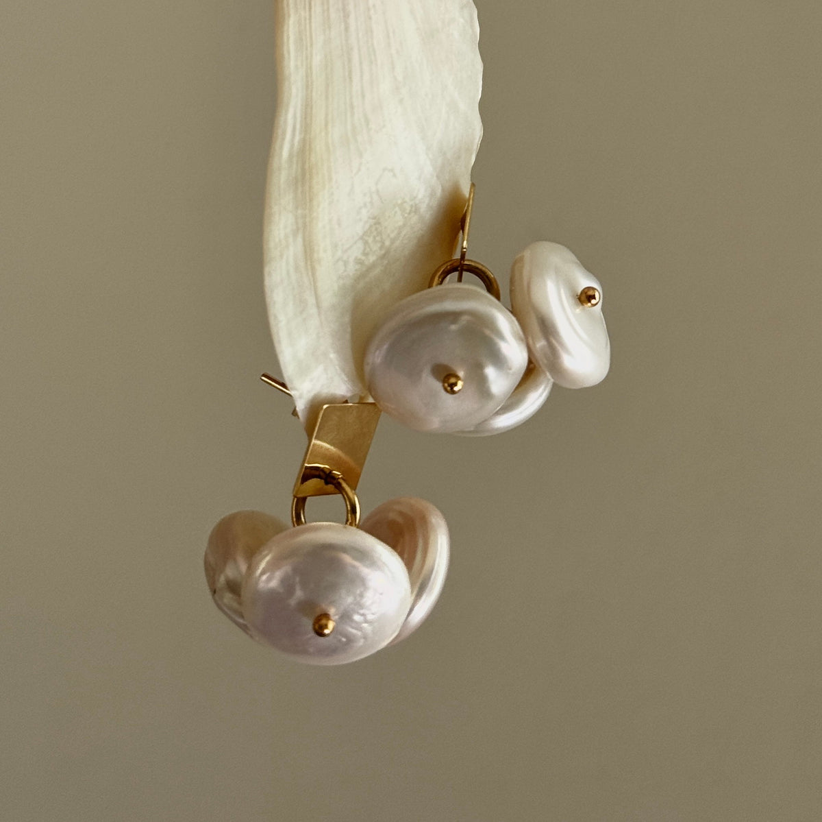 Coin Pearl Earrings, angled close-up of the square stud and the coin pearl cluster